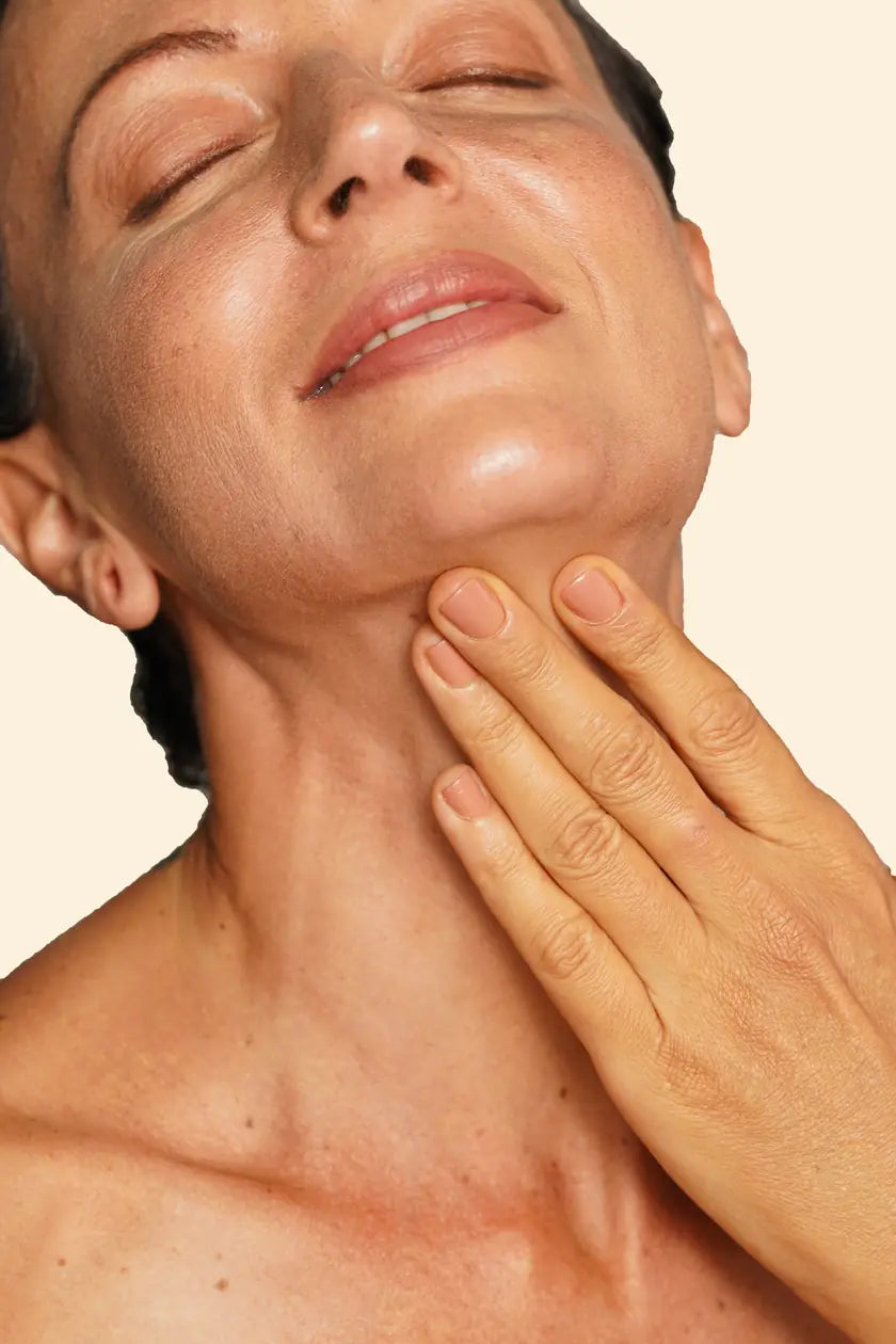 Applying the oil to neck and décolletage